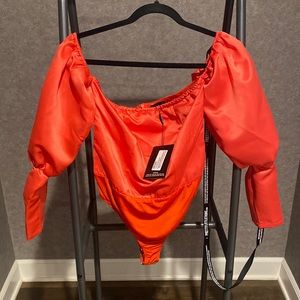 Orange long sleeve body suit. Size 6. Brand PrettyLittleThing